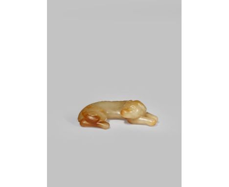 A CHINESE CELADON JADE CARVING OF A HOUND PROBABLY SONG DYNASTY Lying down with his body curved and his head turned to dexter