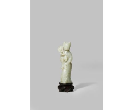 A CHINESE CELADON JADE CARVING OF A YOUNG WOMAN LATE QING DYNASTY Standing holding a large flower stem in her right hand and 