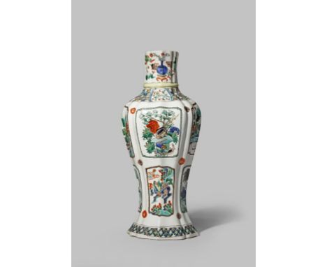 A CHINESE FAMILLE VERTE VASE KANGXI 1662-1722 The moulded body decorated with panels containing prunus, watery landscapes, bi