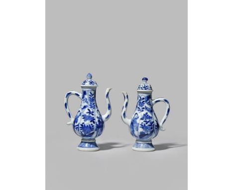 TWO CHINESE SMALL BLUE AND WHITE EWERS KANGXI 1662-1722 Both moulded with panels and painted with young women, flowers and fo