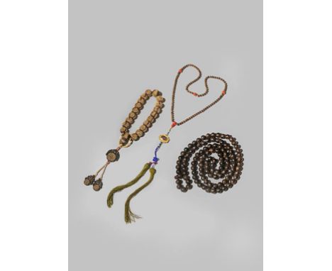 THREE CHINESE HARDWOOD COURT NECKLACES QING DYNASTY OR LATER One formed with nineteen sandalwood beads decorated with gilded 