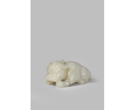 A LARGE CHINESE PALE CELADON JADE CARVING OF A QILIN QING DYNASTY OR LATER Carved crouching, ready to pounce, gazing forward 