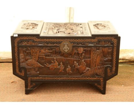Chinese carved camphorwood chest, the stepped top and sides carved with figures in village scenes, on bracket feet, H65 W105 