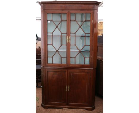 19th century mahogany corner cabinet, the dentil cornice over a pair of astragal glazed doors and cupboard doors on bracket f