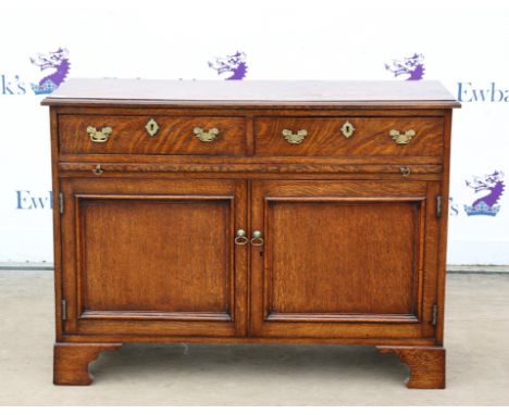 Oak side cabinet, with two frieze drawers, slide and two panelled doors on bracket feet, H78 W107 D40 cm