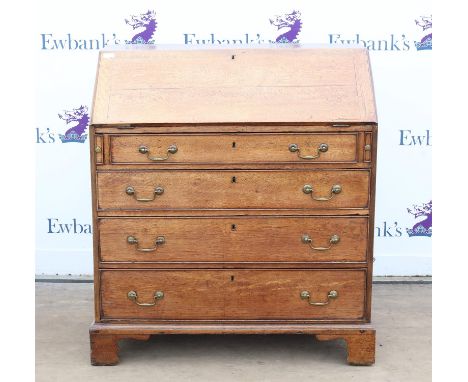George III oak bureau, the sloping fall enclosing pigeon holes and drawers over three long graduated drawers on bracket feet,