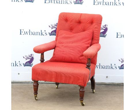 Late Victorian button back armchair with turned legs and brass castors