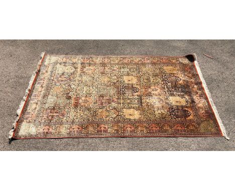 Persian design rug with multiple panels on a light coloured ground 290cm x 180cm