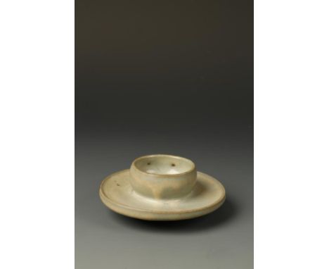 A CHINESE JUNYAO CUP STAND, the slightly rounded upper body above a wide tray and unglazed foot , the light-blue glaze suffus