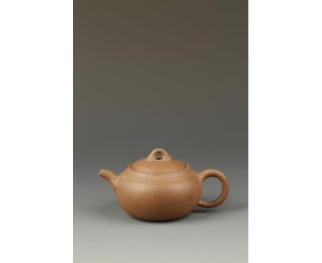 A CHINESE YIXING GLOBULAR TEAPOT with a light 'tea-dust' surface, signed Zhou-zhi Sun Yi, late Qing-Republic, 12.5cm long. Pr