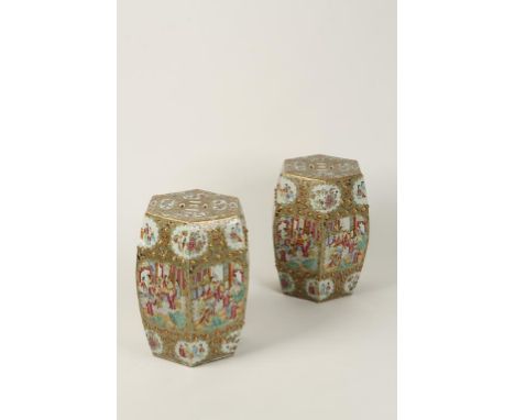 A PAIR OF CHINESE FAMILLE ROSE HEXAGONAL GARDEN SEATS, with pierced sides and tops, decorated with narrative panels of figure