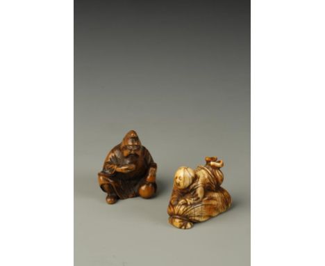 TWO JAPANESE FIGURE NETSUKE, one in ivory of a boy on top of a sack of money, Meiji period, 3.5cm long; the other in wood of 