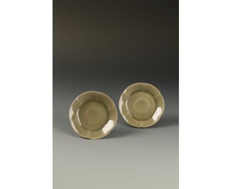 TWO SIMILAR CHINESE YAOZHOU HEXAFOIL DISHES, each with a thick glassy olive glaze with fine bubbles pooling in the centre, No