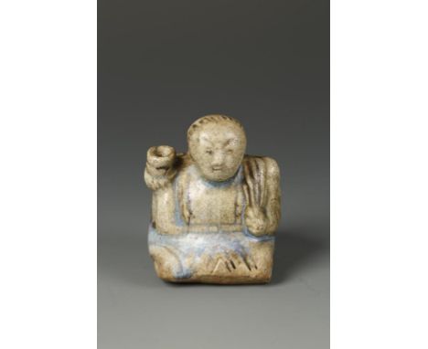 A THAI SAWANKAHLOK JOSS STICK HOLDER, in the form of a kneeling figure, the glaze with some blue areas, 15th-17th century, 7c