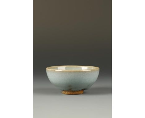 A FINE SMALL CHINESE JUNYAO 'BUBBLE' BOWL, the steep sides of gently rounded form, the thick glaze of milky-blue and moon-whi