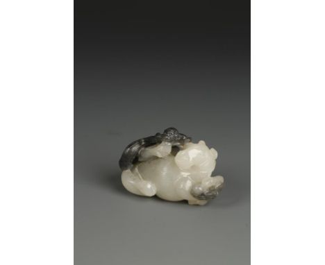 A CHINESE PALE CELADON AND BLACK JADE GROUP, carved as a monkey climbing on a recumbent horse, late Ming - early Qing Dynasty