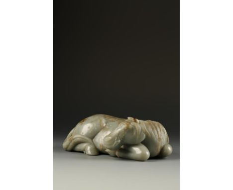 AN IMPORTANT LARGE CHINESE GREEN JADE RECUMBENT HORSE, the animal reclining to one side, its' head turned to the right with e