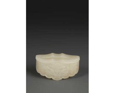 A CHINESE TRANSLUCENT WHITISH JADE FITMENT of ruyi form, with a lobed border, carved on each side with flowers, one side with