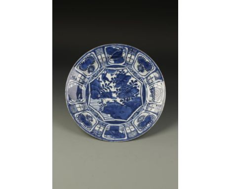 A CHINESE BLUE AND WHITE KRAAK DISH, the centre with an octagonal panel decorated with birds in a garden landscape, within a 