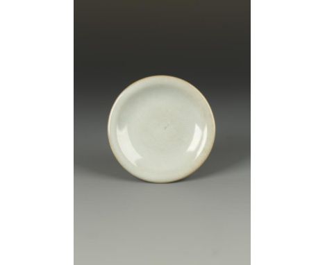 A SMALL CHINESE JUNYAO 'MOON WHITE' SAUCER DISH, the broad everted rim above a gently rounded body, the thick light-blue glaz