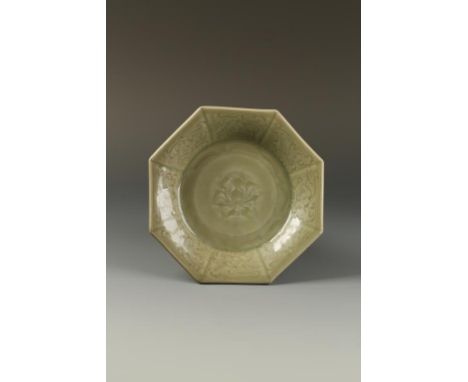 A CHINESE LONGQUAN CELADON OCTAGONAL DISH, the centre with a moulded flower and two-character mark, within an ogee cavetto an