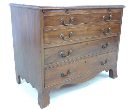 An early 19th century mahogany bachelors chest, brushing slide over four graduating drawers with brass swan neck handles and 