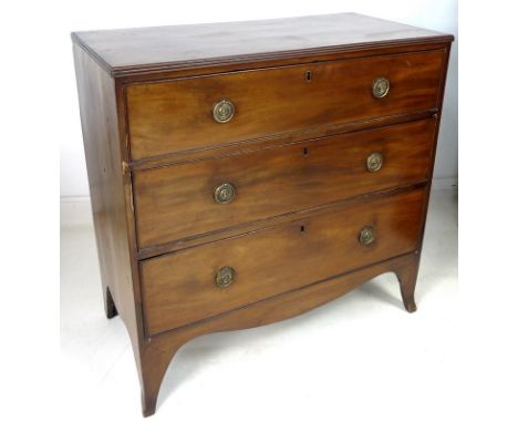 A Regency mahogany chest of three drawers, with cock beading and brass ring handles, raised on splayed bracket feet, with key