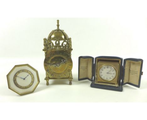 A collection of three early 20th century clocks comprising an Art Deco bedside clock, the octagonal body with ivory face, gol