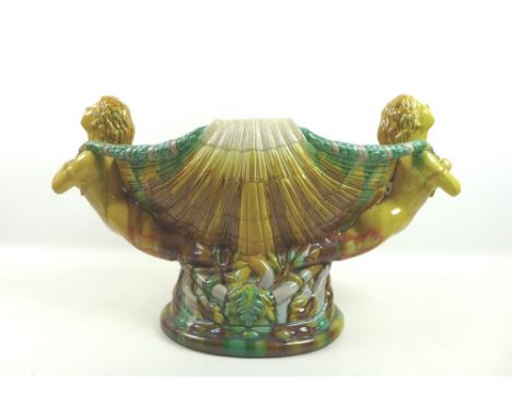 A majolica planter jardiniere, mid 20th century, modelled as a shell with two nude maidens to each side, on an oval base, 56 