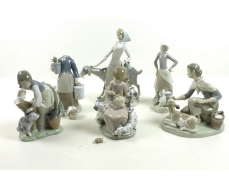 A group of six Lladro figures comprising a girl with a goat, lady with a calf, girl with puppies and bunches, girl with puppy