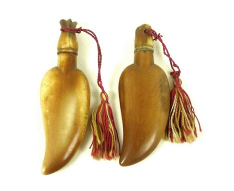 A pair of unusual ivory scent bottles, probably Chinese 19th century, carved in the shape of a claw or a leaf, the carved scr