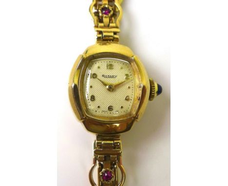 A 9ct gold lady's cocktail watch by Rotary, the crown set with a blue stone cabochon, cream dial with gold Arabic numerals an