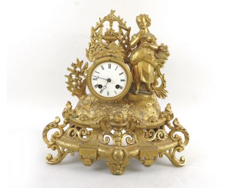 A French late 19th century gilt metal figural mantel clock, modelled as a lady with a basket of flowers and a bird, white ena