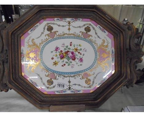 A gilt framed ceramic tray.