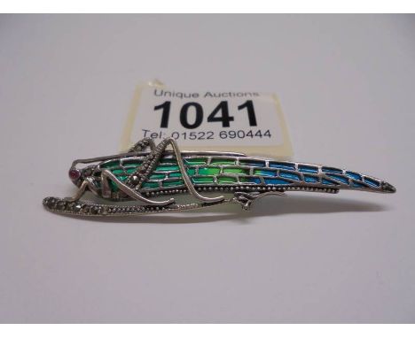 A ruby, pyrate and plique-a-jour enamel brooch designed as a grasshopper, stamped 925, length 7.2 cm. In very good condition