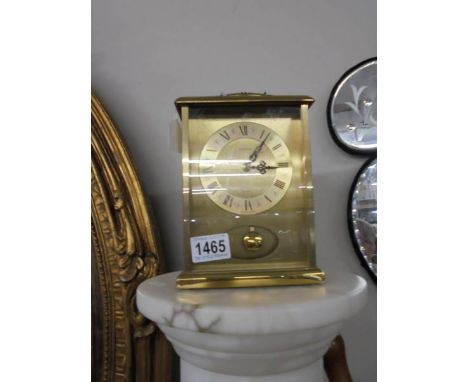A brass mantel clock.