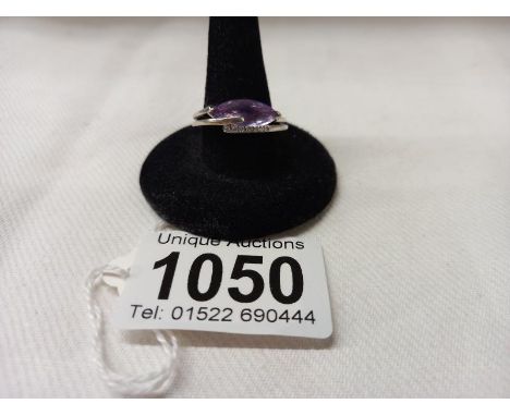 A 9ct white gold ring set amethyst and seven diamonds, size N, 4.4 grams.