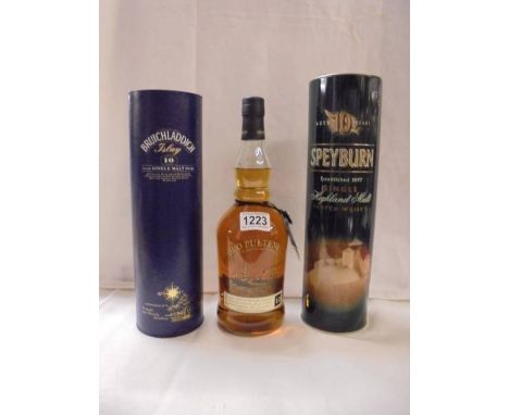 A bottle of Speyburn, a bottle of Bruichladdick and a bottle of Old Pulteney scotch whisky. 
