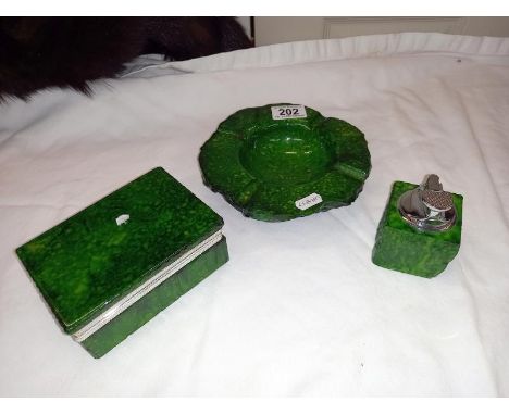 A green Onyx smokers kit. Lighter, ashtray and cigarette case.