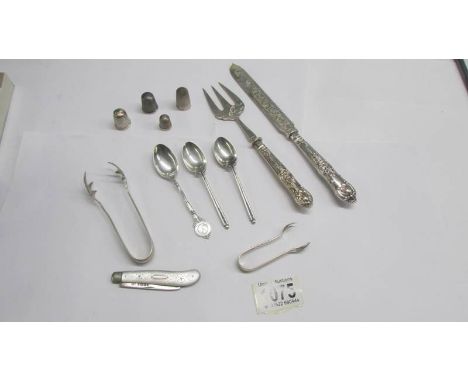 Three silver tea spoons, silver sugar nips, silver thimbles, silver handled knife and fork etc.,
