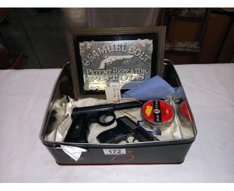 A Harrington air pistol A/F, a novelty gun cigarette lighter and a Samuel Colt advertising mirrorCOLLECT ONLY