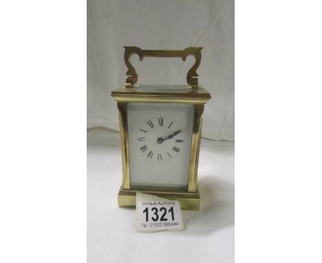 A brass carriage clock with key.