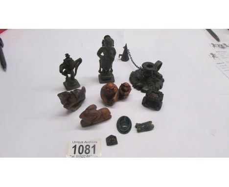 A mixed lot of oriental metal figures, stone figures, netsuke and a chamber candlestick.