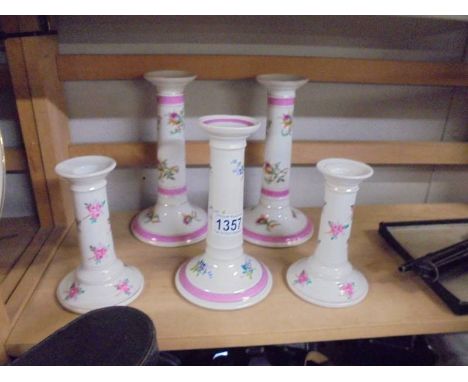 Two pairs and a single ceramic candlesticks.