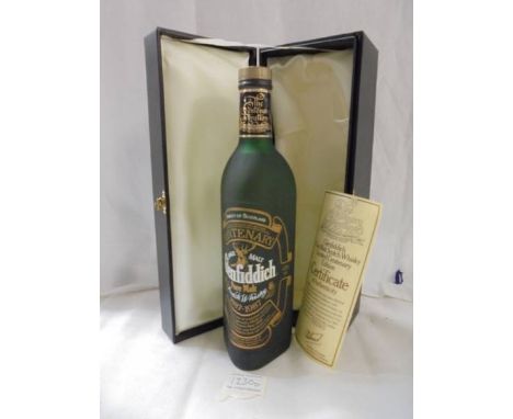 A boxed bottle of centenary Glenfiddich Scotch whisky. 