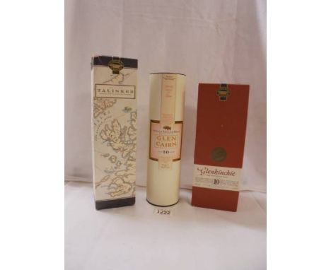 A bottle of Talisker, a bottle of Glenkinchie and a bottle of Glen Cairn Scotch whisky. 