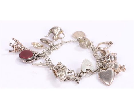 Silver charm bracelet, with various charms to include pot, owl, seal, dice, typewriter, etc, 35 grams