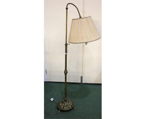 Standard lamp, the adjustable lamp raised on a gadrooned base