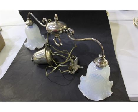 Silver plated rise and fall lamp, the two scrolled arms each terminating with a frilled vaseline glass shade, 56cm wide
