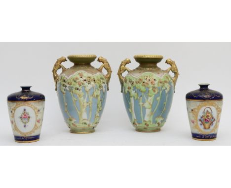 A pair of Noritake twin handled vases, handles in the form of exotic birds, decorated with floral patterns, 20cm tall, togeth